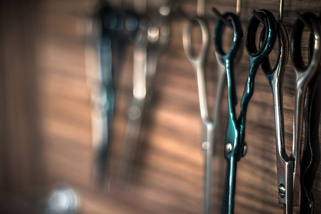 Row of hair-cutting shears hanging at a styling station