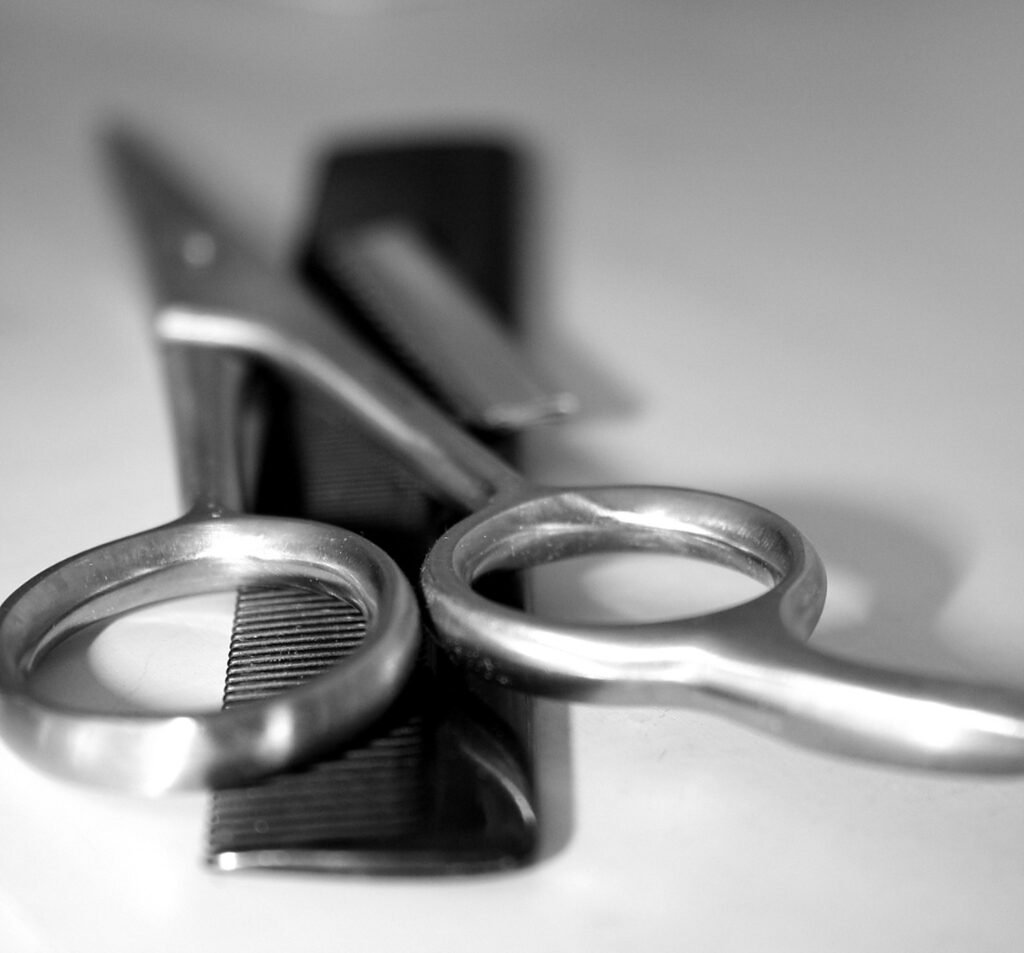 Hair-cutting shears resting on a comb