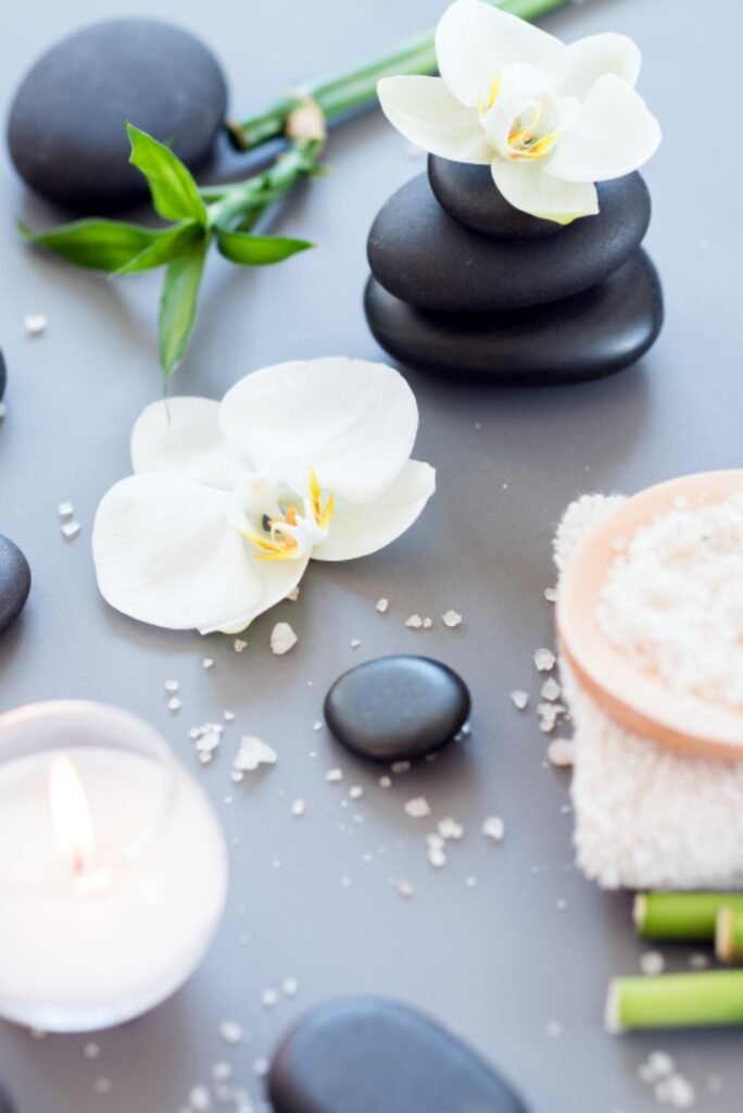 Spa stones, orchids and a candle for skin care